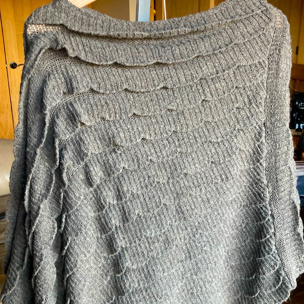 Brown knit poncho with scalloped overlay pattern